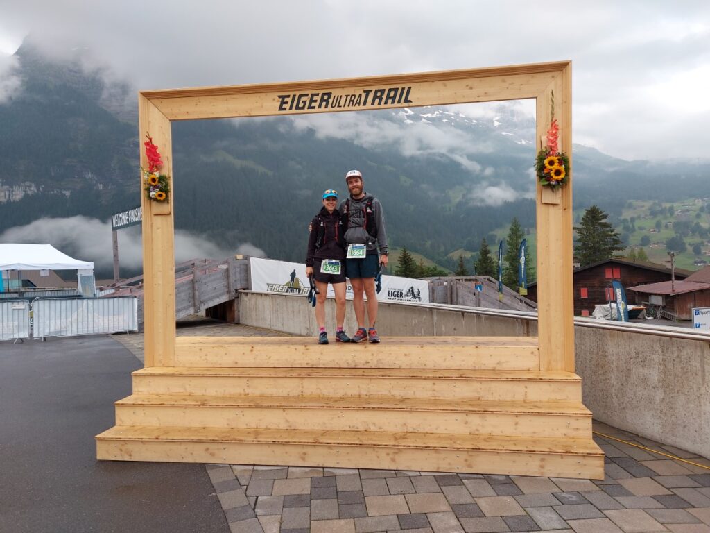 couple posing before the Eiger Ultra Trail E35 in front of the Eiger in Grindelwald Switzerland