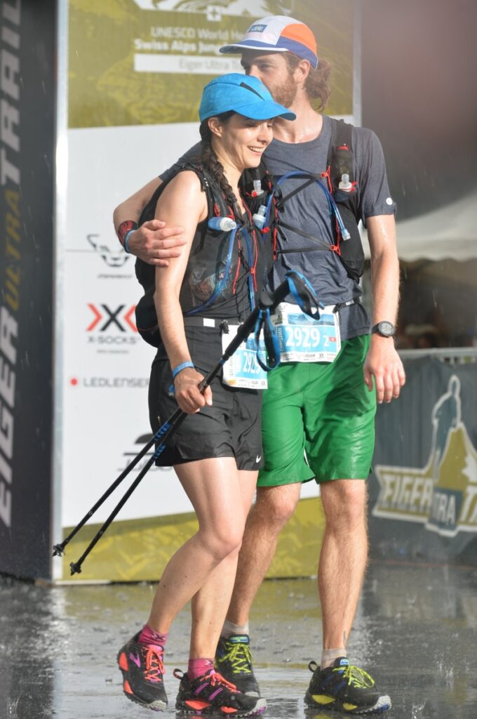 couple in the rain at the finish line of the ultramarathon trail running event Eiger Ultra Trail E51 in Grindelwald Switzerland
