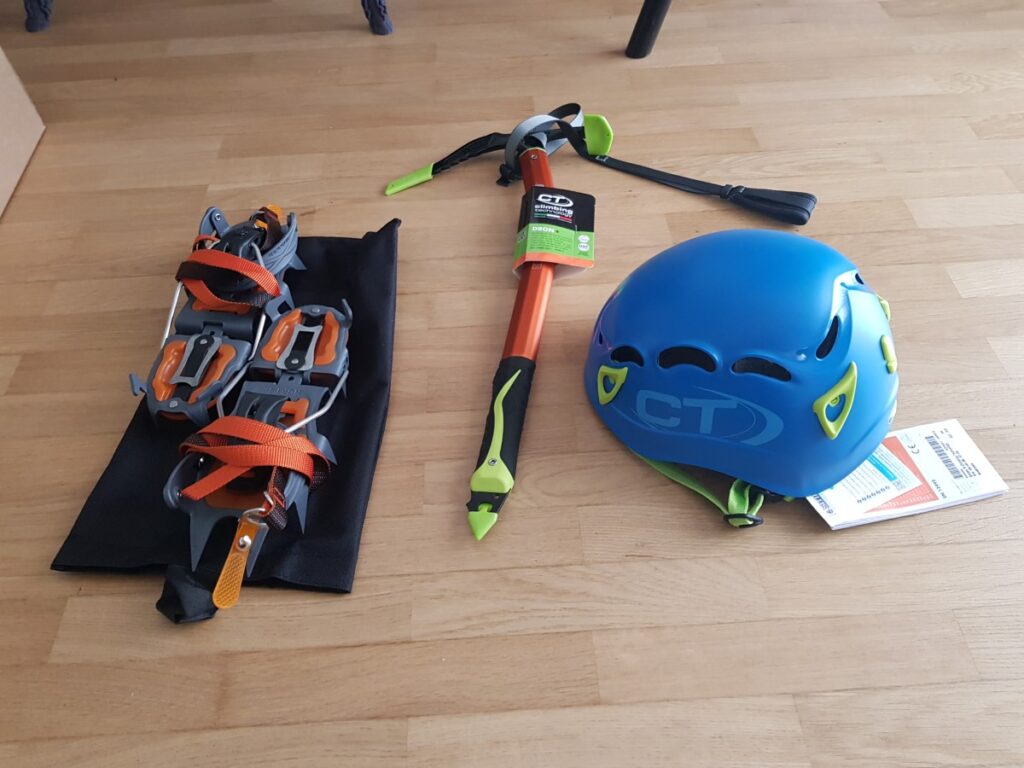 Crampons, ice axe and helmet for mountaineering