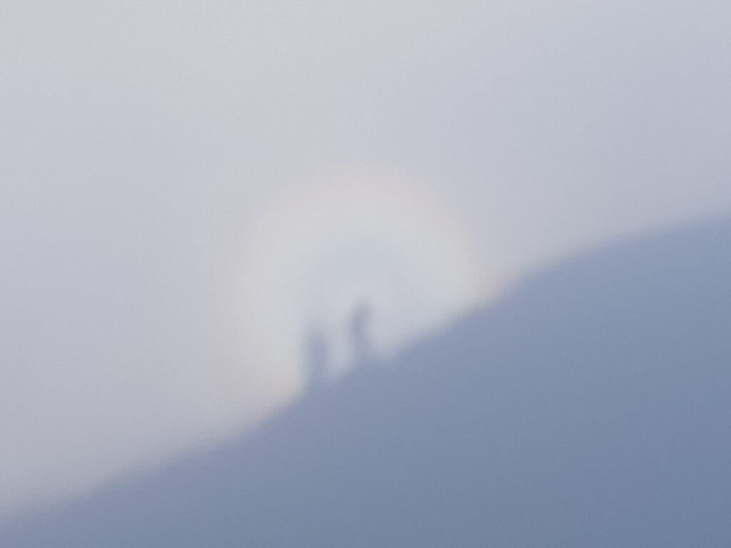 Shadow of two people on the fog Faulhorn Grindelwald Switzerland
